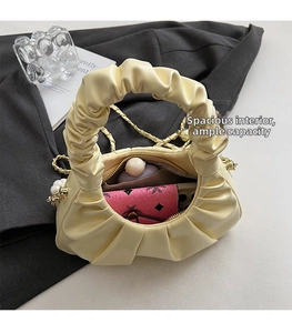 Interior view showing the large capacity of the yellow pleated cloud bag with chain