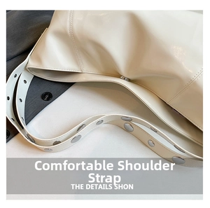 Detail of off-white crescent bag strap with silver metal eyelets and rivets