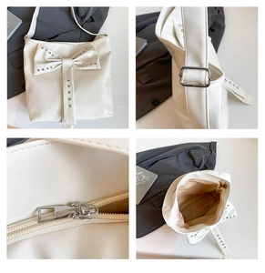 Detail view of beige shoulder bag with large bow, metal rivets, and interior storage