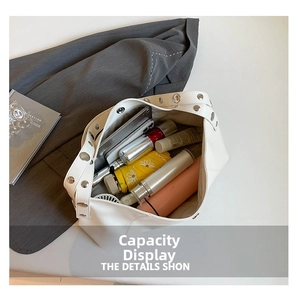 Spacious white PU tote bag showing interior storage for phone, umbrella, and water bottle