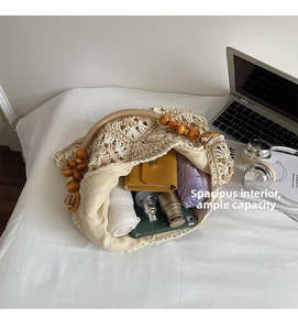 Spacious interior of beige woven tote bag holding a wallet, umbrella, and water bottle