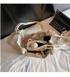 Spacious interior of a cream lychee-grain bucket bag showing ample storage with an inner pouch