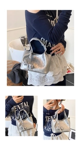 Détails du sac seau tressé argenté avec pampille à nœud et bandoulière en chaîne métal