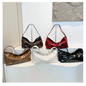Detailed display of crescent bags in five colors with glossy wax finish and metal buckles