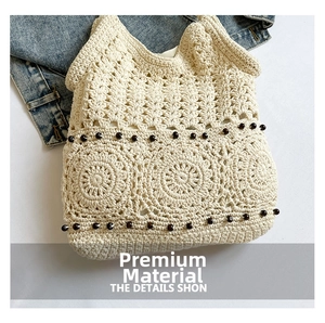 Detail of off-white woven tote bag featuring hollow crochet and dark brown wooden beads