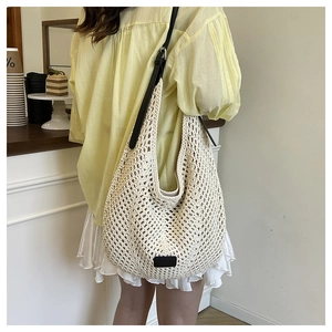 Detail of handwoven crochet tote bag showing honeycomb texture and leather strap