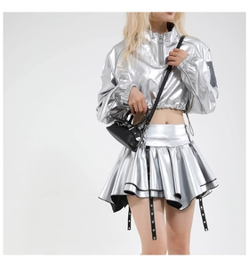 Detail of silver metallic Y2K set with cropped zipper top and pleated mini skirt