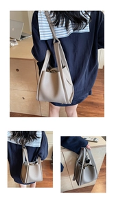 Detailed view of light grey lychee pattern leather bucket bag with dual handles