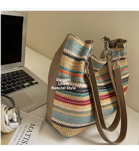 Detail of multi-color woven tote bag with brown leather handles and canvas side panels