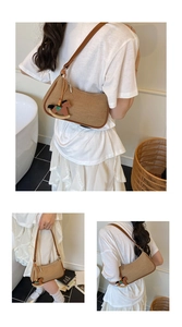 Detail view of a vintage canvas shoulder bag with brown leather trim and a wooden horse charm