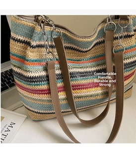 Detail of colorful striped woven tote bag with leather straps and decorative metal rings