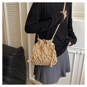 Close-up of beige crochet bucket bag featuring bohemian hollow patterns and drawstring
