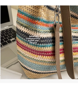 Close-up of woven straw tote bag featuring colorful stripes and premium leather straps