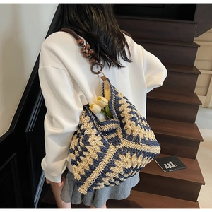Detail of woven tote bag with blue diamond pattern and wooden bead shoulder strap