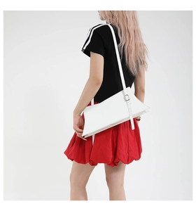 Détail d'un sac à bandoulière minimaliste en cuir blanc avec sangle réglable