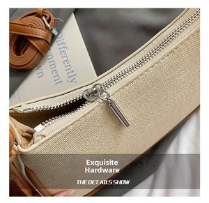 Detailed close-up of premium silver metal zipper and brown leather trim on beige handbag