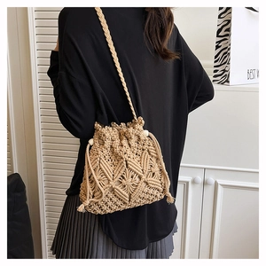 Detail of hand-woven macramé bucket bag featuring intricate diamond patterns and tassels