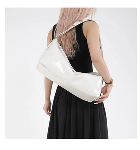 Detailed back view of white crescent hobo bag with adjustable wide strap and metal grommets