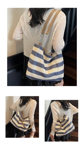 Detail of colorful striped woven tote bag with brown leather straps and metal link rings
