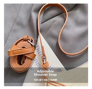 Detail of adjustable brown leather shoulder strap with silver metal buckles on handbag