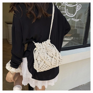 Detail of macrame star pattern on cream cotton crochet bucket bag with drawstring