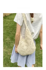 Close-up of cream crochet tote bag featuring hollow petal knit patterns and natural texture