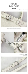 Detail view of white pebbled leather bag with silver hardware and heart-shaped charm