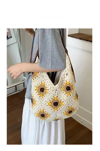 Detail of hand-woven sunflower crochet shoulder bag with brown leather straps for women