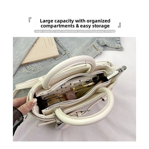 Interior view of cream leather tote showing spacious compartments and daily essentials