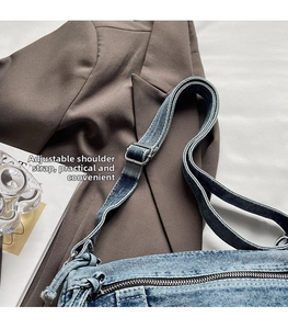 Detail of adjustable washed denim strap and metal buckle on vintage crossbody bag