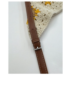 Close-up of adjustable leather strap and woven sunflower crochet shoulder bag detail