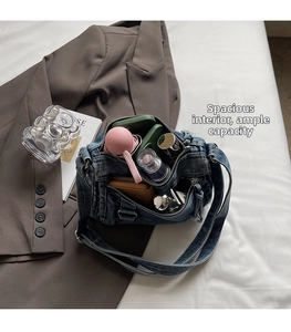 Detail view of denim crossbody bag interior showing spacious capacity for daily items