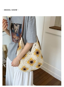 Detailed view of handmade knitted tote bag with sunflower pattern and leather strap