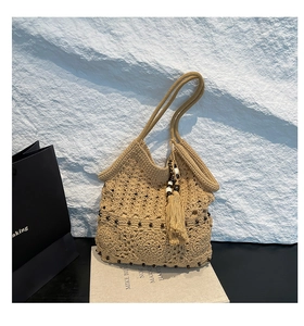 Close-up of handmade crochet tote bag with hollow floral patterns and wood beads