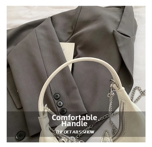 Close-up of white PU leather bucket bag featuring silver chain and metal zipper detail