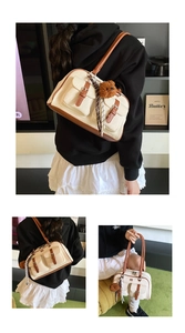 Detail of canvas bag with leather trim, plush bear charm and checkered silk scarf