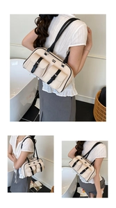Close-up of canvas pillow bag with dual buckle pockets and leather trim accents