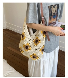 Detail of hand-woven sunflower crochet tote bag with brown leather shoulder strap