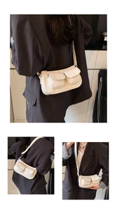 Three-way view of cream-colored shoulder bag with functional dual front flap pockets