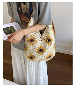 Close-up of hand-crocheted sunflower tote bag featuring brown leather straps and floral weave