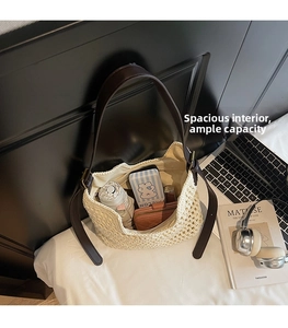 Top view of spacious cream crochet hobo bag with leather strap and daily essentials