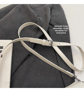 Detail of adjustable white leather shoulder strap with silver buckle and smooth edge oil finish