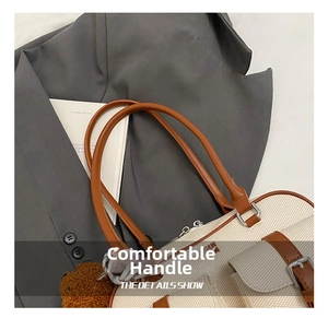 Detail view of canvas pillow tote bag featuring brown leather straps and a plush bear charm