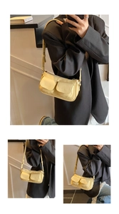 Detail of yellow baguette shoulder bag featuring front double pockets and adjustable strap