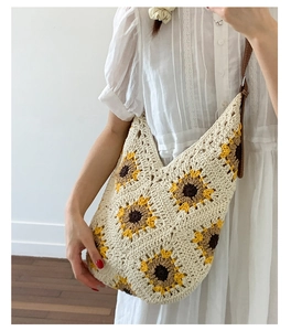 Detailed knit crochet tote bag featuring sunflower patterns and brown leather straps