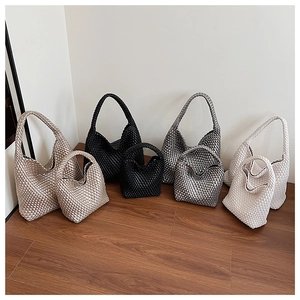 Detail view showing woven hobo bag texture and sizes in champagne, black, and silver