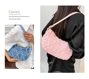 Detail of frayed denim hobo bag with quilted texture in sky blue and pink pastel tones