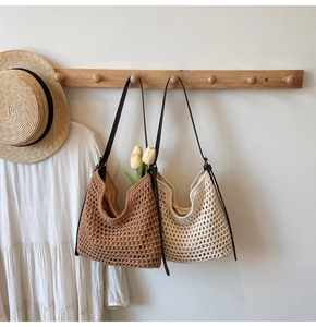 Close-up of woven cotton shoulder bag featuring a hollow-out texture and leather strap