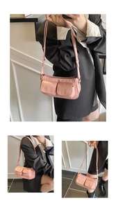 Detailed view of pink glossy crossbody bag with dual front pockets and adjustable strap