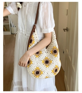 Detail of sunflower crochet hobo bag featuring brown leather strap and knit texture
